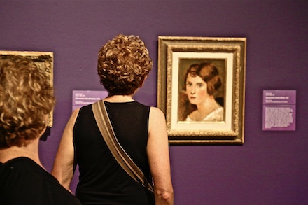 Photo by John Levy of two women viewing Portrait de Femme, a painting by Andre Derain