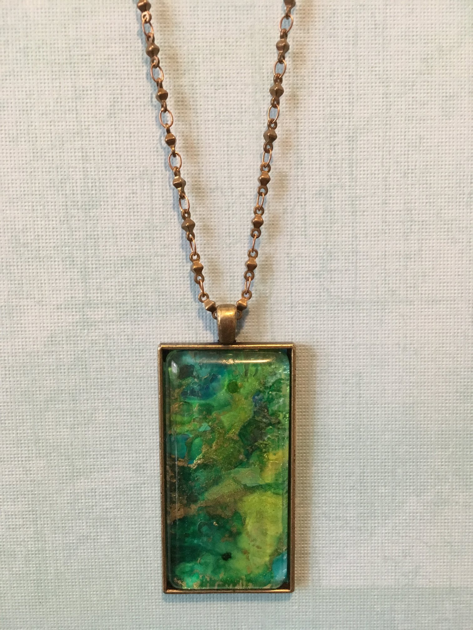 Pendant with bezel by Susan Tekulve and painting by Claire Bateman